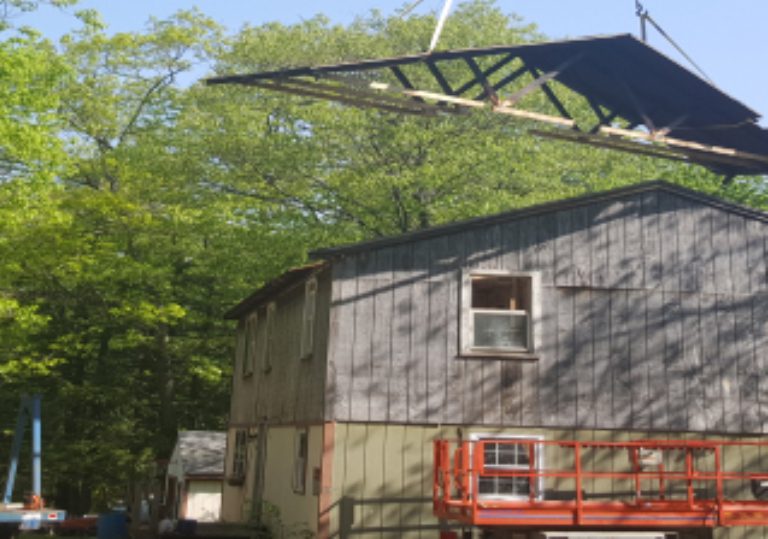 Crane lifting the roof of the house